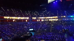 Crowd holding up their phone screens during an interval between matches or map change.