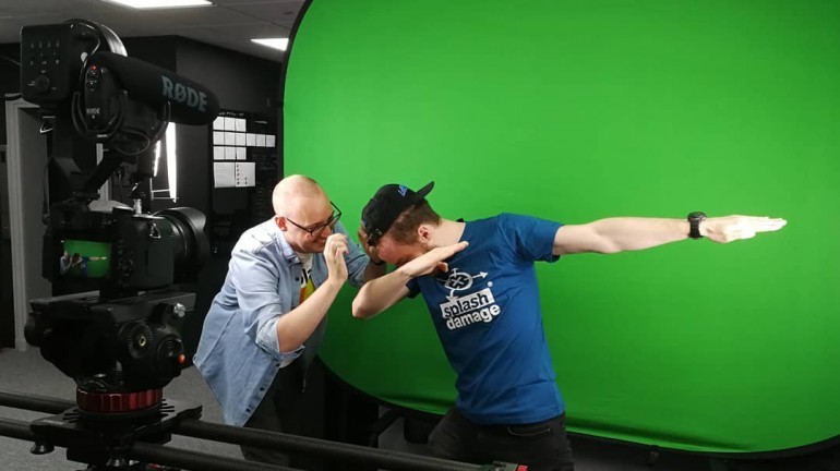 A picture of Luc Shelton (myself) posing or "dabbing" in front of a green screen for the media and marketing team.